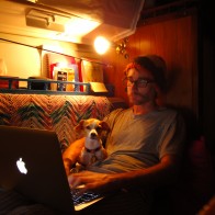 sailboat-catalina-san-diego A young man works on the computer with his dog.