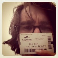 A young man showing off his San Diego Sea World ticket.