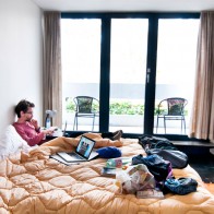 beersandbeans_hostelbookers_Backpackers Lucerne A traveler relaxing on a bed in Backpackers Lucerne in Switzerland.