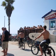 Two men on beach cruisers in Pacific Beach, California.